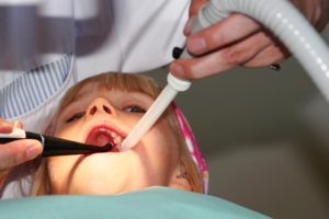 Little girl laying down after sedation, during a dental procedure